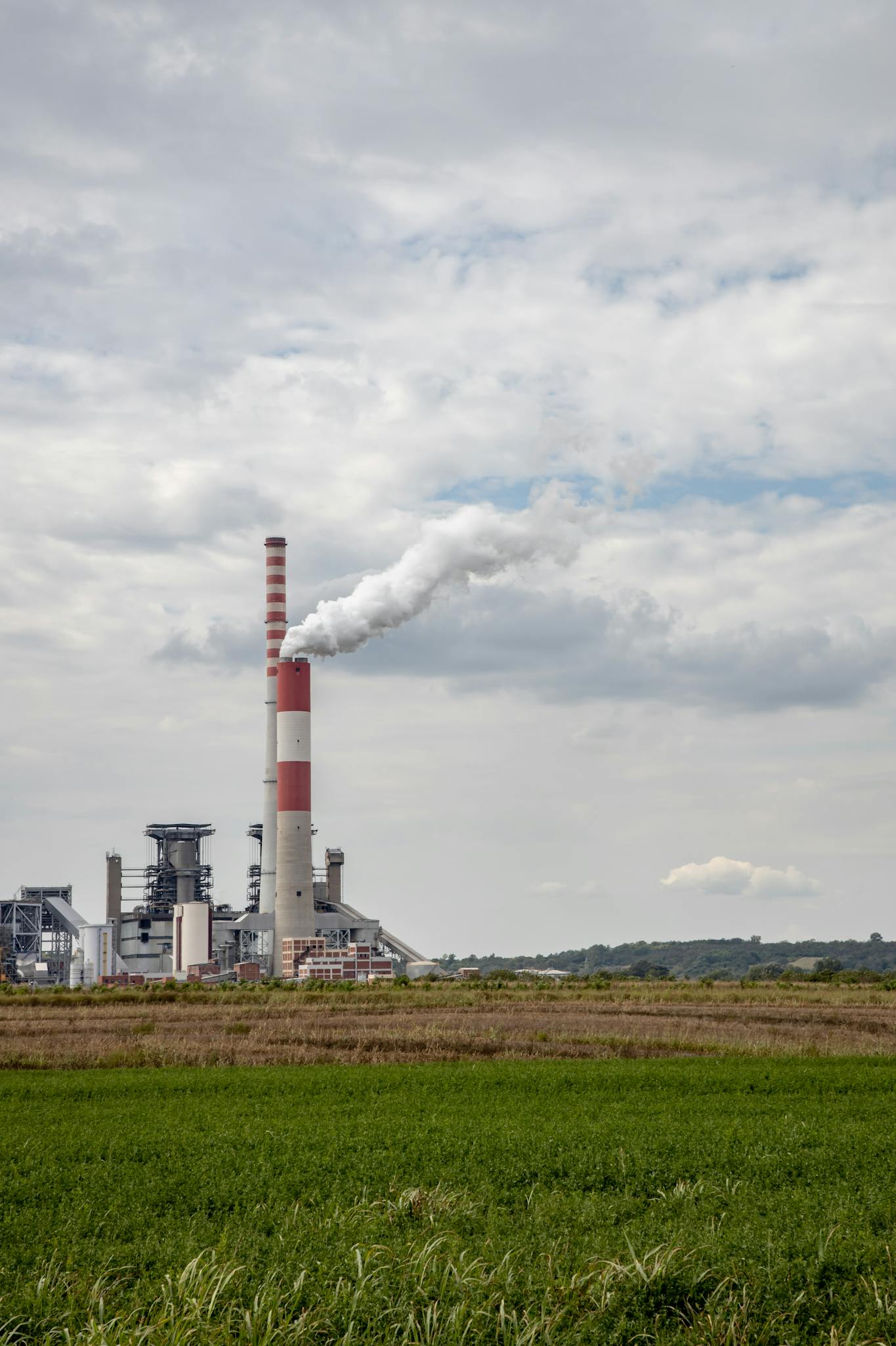 View of a power plant emitting smoke, showcasing industrial energy production.